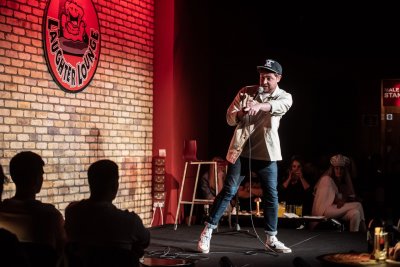 comedian on stage pointing to audience member