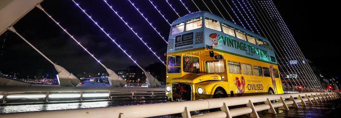 vintage tea tour bus on beckett bridge, dublin city, ireland